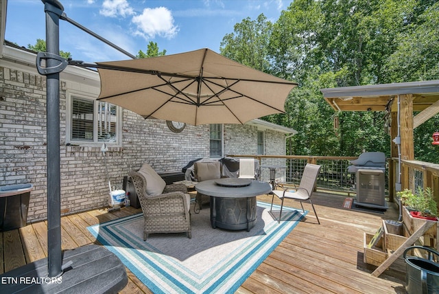 wooden deck featuring a grill and an outdoor hangout area