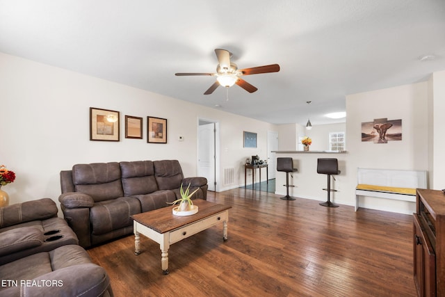 living room featuring dark hardwood / wood-style floors and ceiling fan