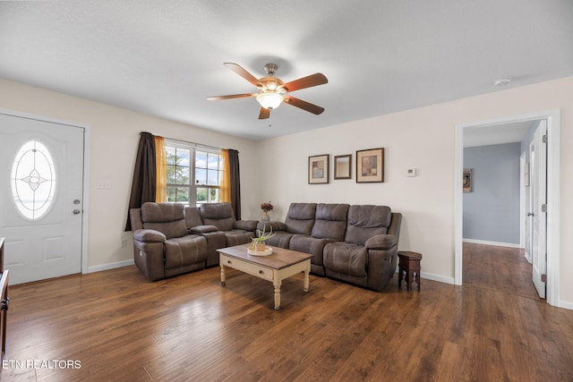 living room with dark wood-type flooring and ceiling fan