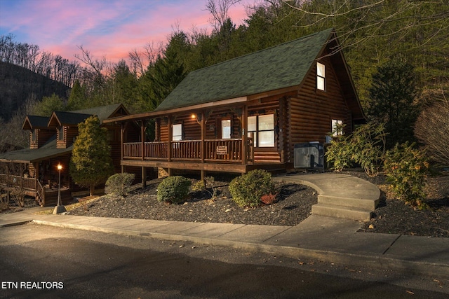 log-style house featuring a porch