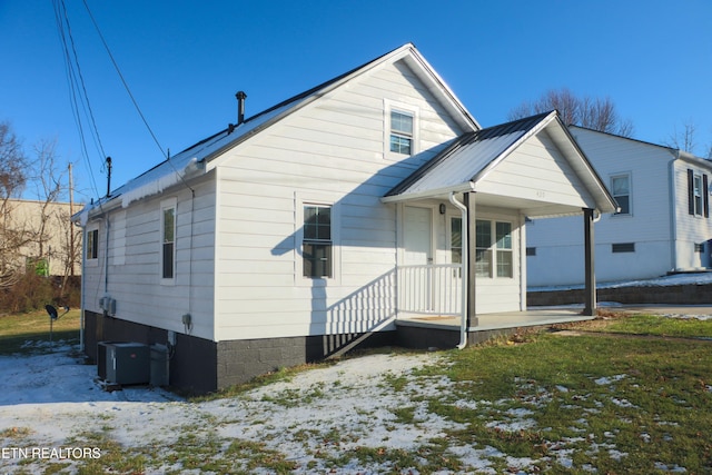 rear view of property featuring central AC unit