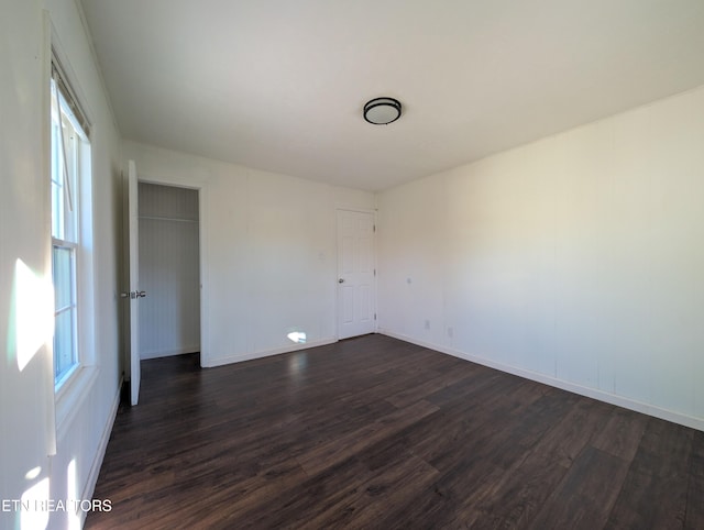 empty room featuring dark wood-type flooring