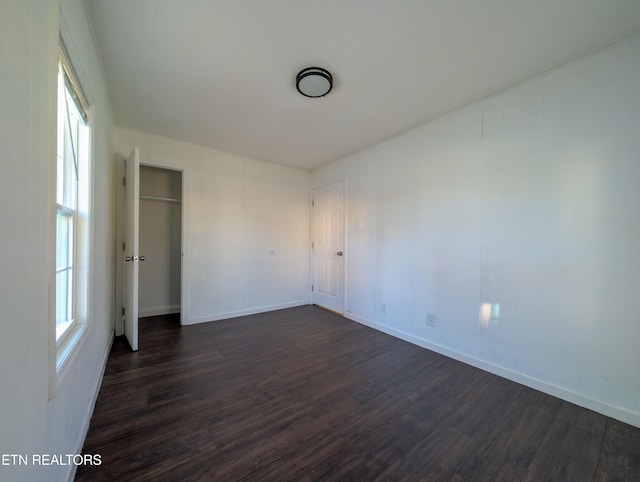 unfurnished room featuring dark hardwood / wood-style floors