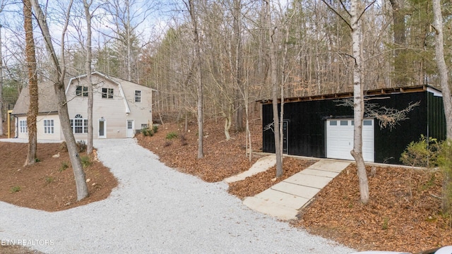 view of property featuring a garage and an outdoor structure