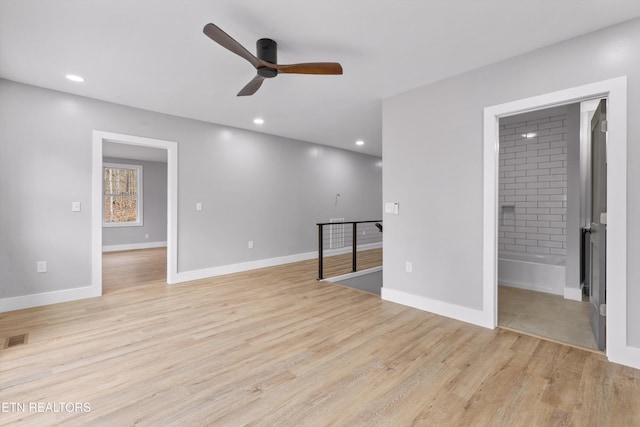 unfurnished room featuring ceiling fan and light hardwood / wood-style flooring