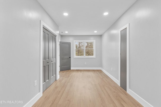 corridor with light hardwood / wood-style floors