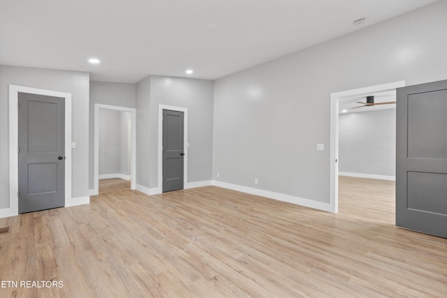 interior space featuring a closet, a spacious closet, and light hardwood / wood-style flooring