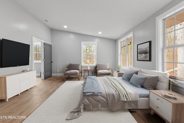 bedroom with light hardwood / wood-style flooring and vaulted ceiling