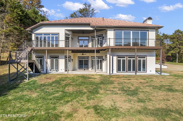 back of house featuring ceiling fan, a yard, and a patio