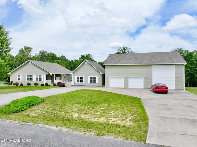 view of front of home featuring a front yard, a porch, and a garage