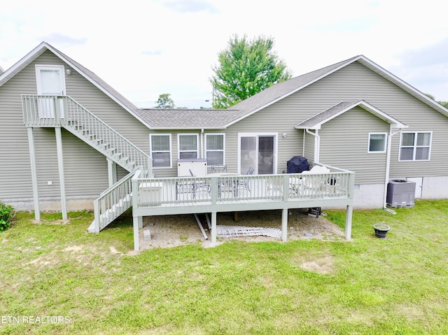 rear view of house with a yard, a deck, and central air condition unit