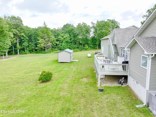 view of yard with a storage unit and a wooden deck