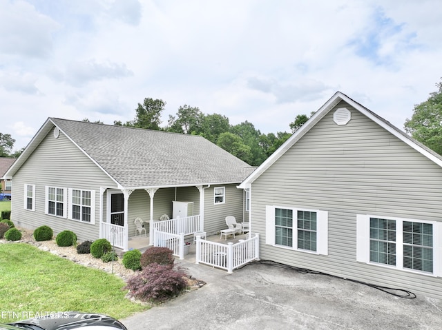 rear view of property with a yard