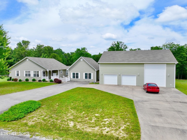 ranch-style house featuring a porch, a garage, and a front lawn