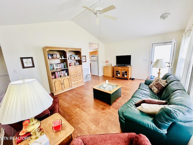 living room with hardwood / wood-style floors, vaulted ceiling, and ceiling fan