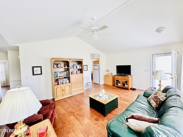 living room featuring hardwood / wood-style floors, ceiling fan, and vaulted ceiling