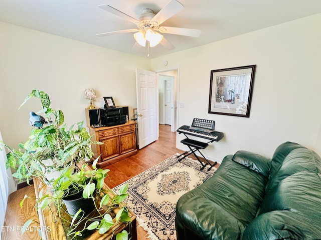 living room featuring light wood-type flooring and ceiling fan