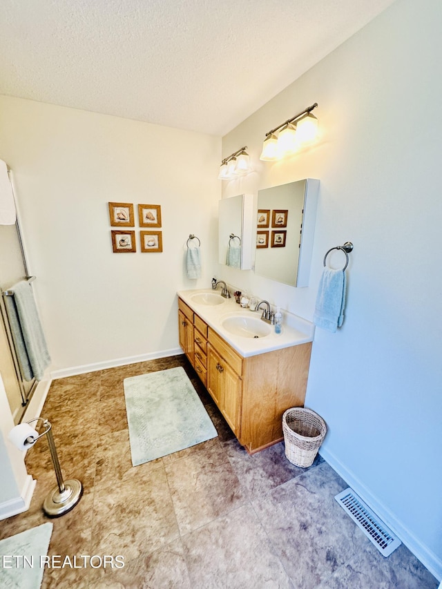 bathroom featuring vanity and a textured ceiling