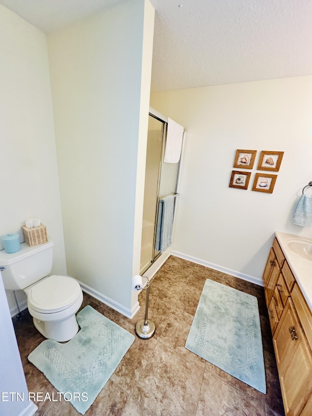 bathroom featuring vanity, toilet, and walk in shower