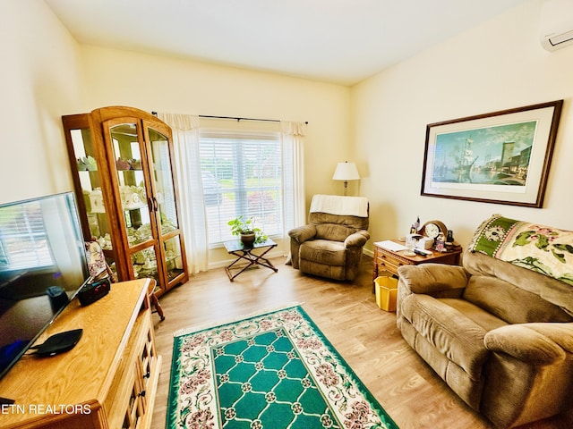 interior space featuring an AC wall unit and light hardwood / wood-style flooring