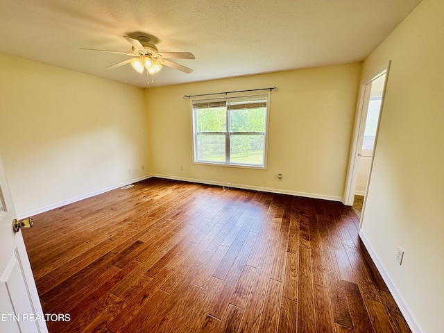 813 Clear Creek Pkwy, Clarkrange, TN 38553 - spare room featuring dark wood-type flooring, a ceiling fan, and baseboards