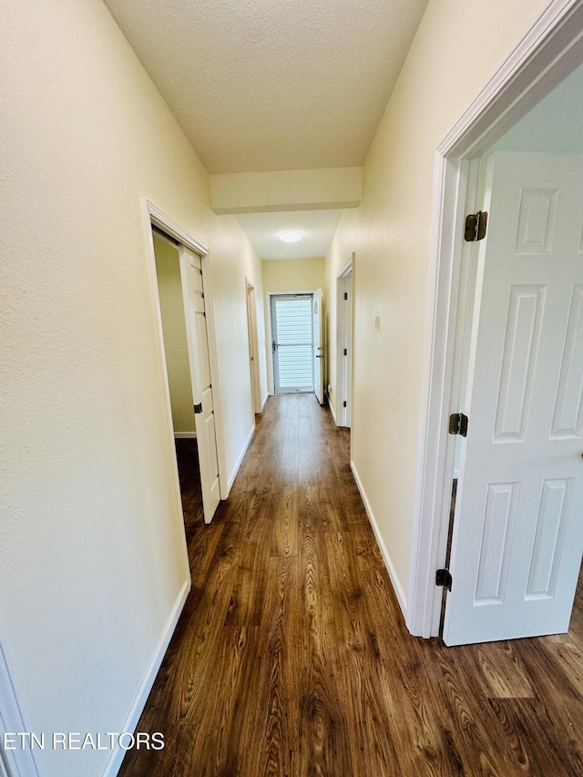 813 Clear Creek Pkwy, Clarkrange, TN 38553 - hallway with dark wood-style flooring, baseboards, and a textured ceiling