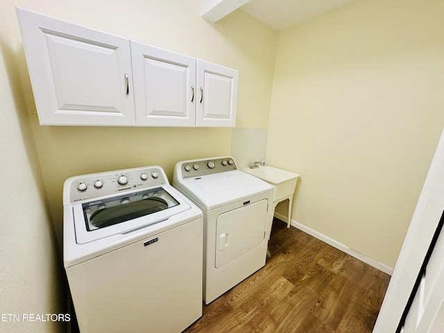 813 Clear Creek Pkwy, Clarkrange, TN 38553 - laundry area featuring washing machine and dryer, cabinet space, wood finished floors, and baseboards