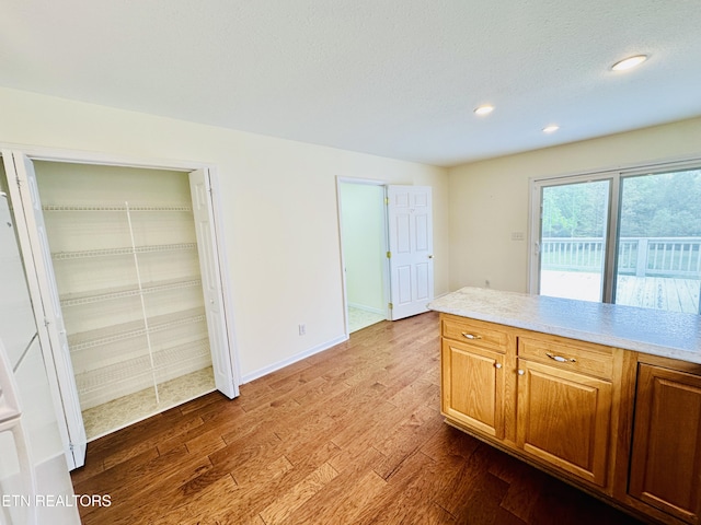 813 Clear Creek Pkwy, Clarkrange, TN 38553 - kitchen featuring wood finished floors, light countertops, recessed lighting, baseboards, and brown cabinets