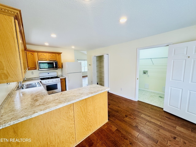 813 Clear Creek Pkwy, Clarkrange, TN 38553 - kitchen featuring white appliances, a sink, light countertops, dark wood-type flooring, and a peninsula