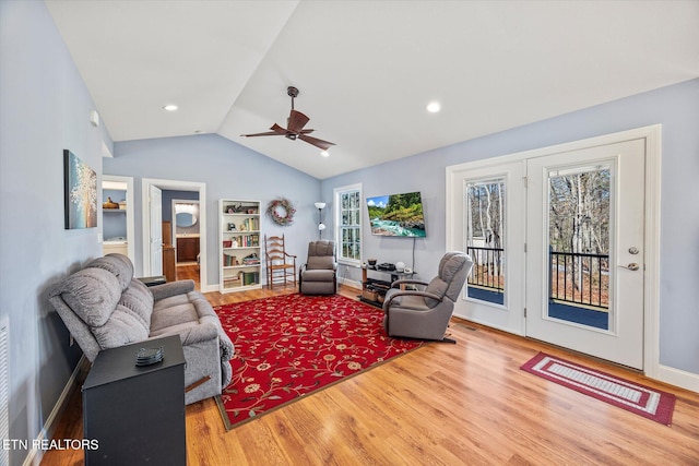 living room featuring ceiling fan, vaulted ceiling, and hardwood / wood-style floors