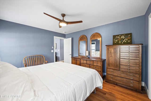 bedroom with ceiling fan and dark wood-type flooring