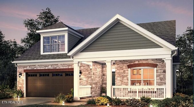 view of front of property featuring a garage and covered porch