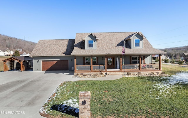 view of front of home with covered porch, a front yard, and a garage