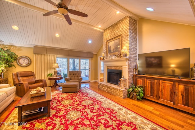 105 Charity Ln, Jamestown, TN 38556 - living area featuring wooden ceiling with exposed beams, wood finished floors, a brick fireplace, ceiling fan, and high vaulted ceiling