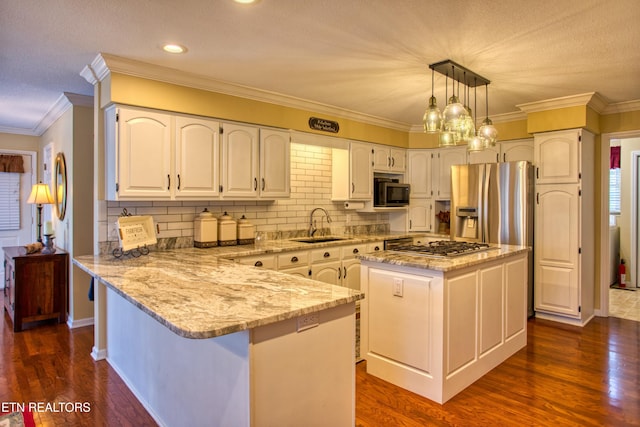105 Charity Ln, Jamestown, TN 38556 - kitchen featuring stainless steel appliances, a sink, a peninsula, light stone countertops, and white cabinetry