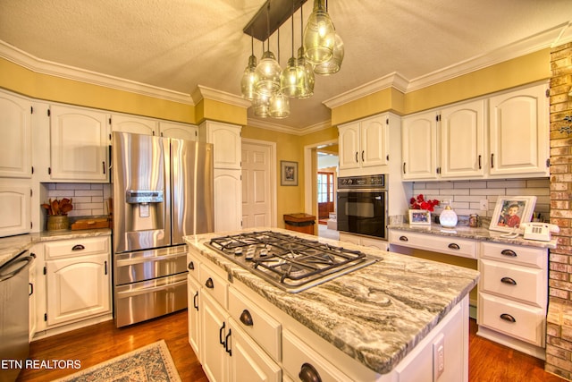 105 Charity Ln, Jamestown, TN 38556 - kitchen featuring stainless steel appliances, dark wood finished floors, light stone countertops, a textured ceiling, and decorative backsplash