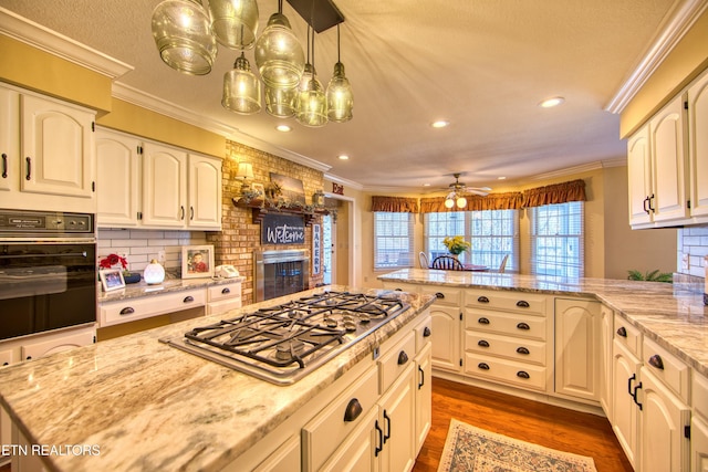 105 Charity Ln, Jamestown, TN 38556 - kitchen featuring oven, stainless steel gas stovetop, crown molding, a peninsula, and recessed lighting