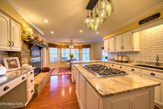 105 Charity Ln, Jamestown, TN 38556 - kitchen with stainless steel gas cooktop, a sink, crown molding, plenty of natural light, and dark wood finished floors