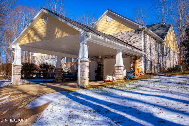 105 Charity Ln, Jamestown, TN 38556 - view of snowy exterior with brick siding and driveway