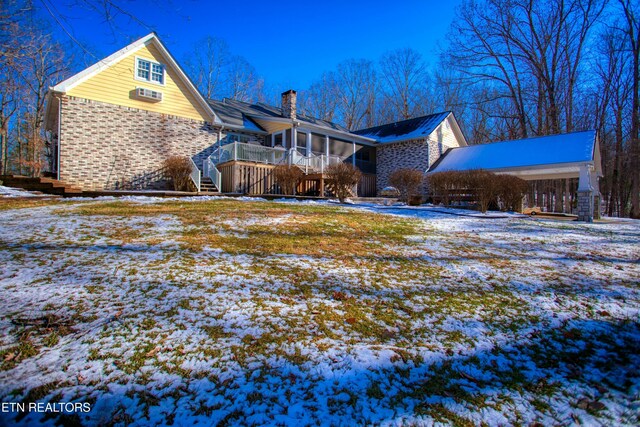 105 Charity Ln, Jamestown, TN 38556 - snow covered house featuring stairway, a sunroom, a chimney, a wooden deck, and brick siding