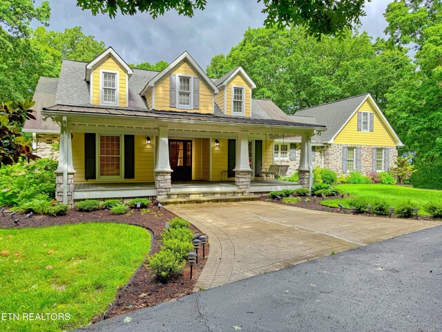 105 Charity Ln, Jamestown, TN 38556 - new england style home with a porch, stone siding, and a front yard