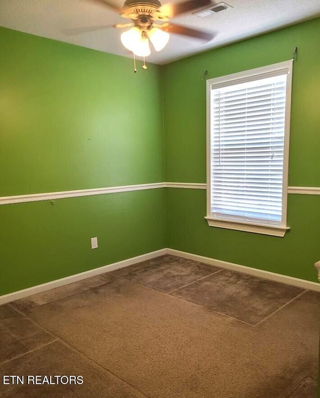 carpeted empty room featuring ceiling fan