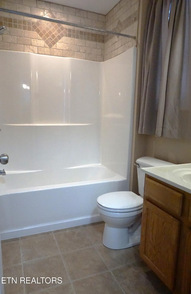 full bathroom featuring tile patterned floors, toilet, vanity, and washtub / shower combination