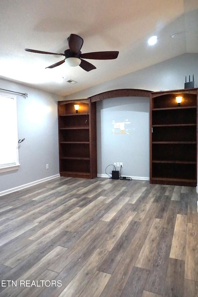 interior space featuring ceiling fan, hardwood / wood-style floors, and vaulted ceiling