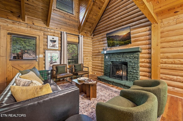 living room featuring hardwood / wood-style floors, high vaulted ceiling, a fireplace, beam ceiling, and wood ceiling