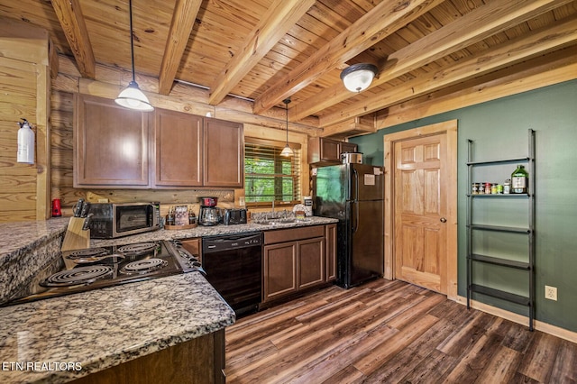 kitchen with dark hardwood / wood-style flooring, light stone counters, black appliances, pendant lighting, and beam ceiling