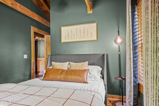 bedroom with vaulted ceiling and hardwood / wood-style flooring