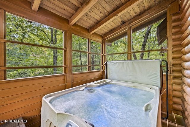 sunroom / solarium with beamed ceiling, wooden ceiling, and a hot tub