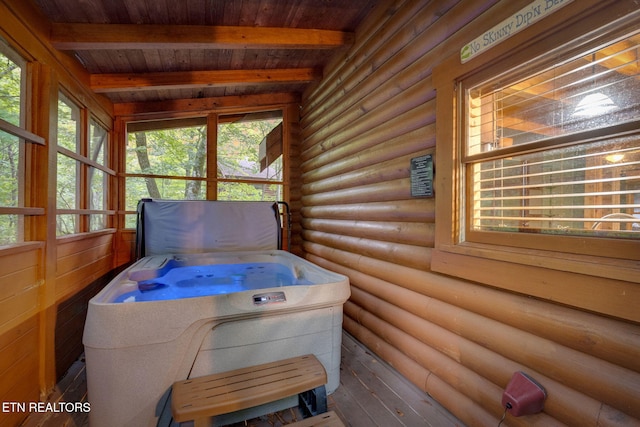 interior space featuring beam ceiling, wood ceiling, and a jacuzzi