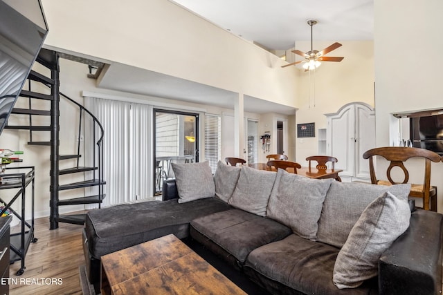 living room featuring ceiling fan, hardwood / wood-style flooring, and lofted ceiling